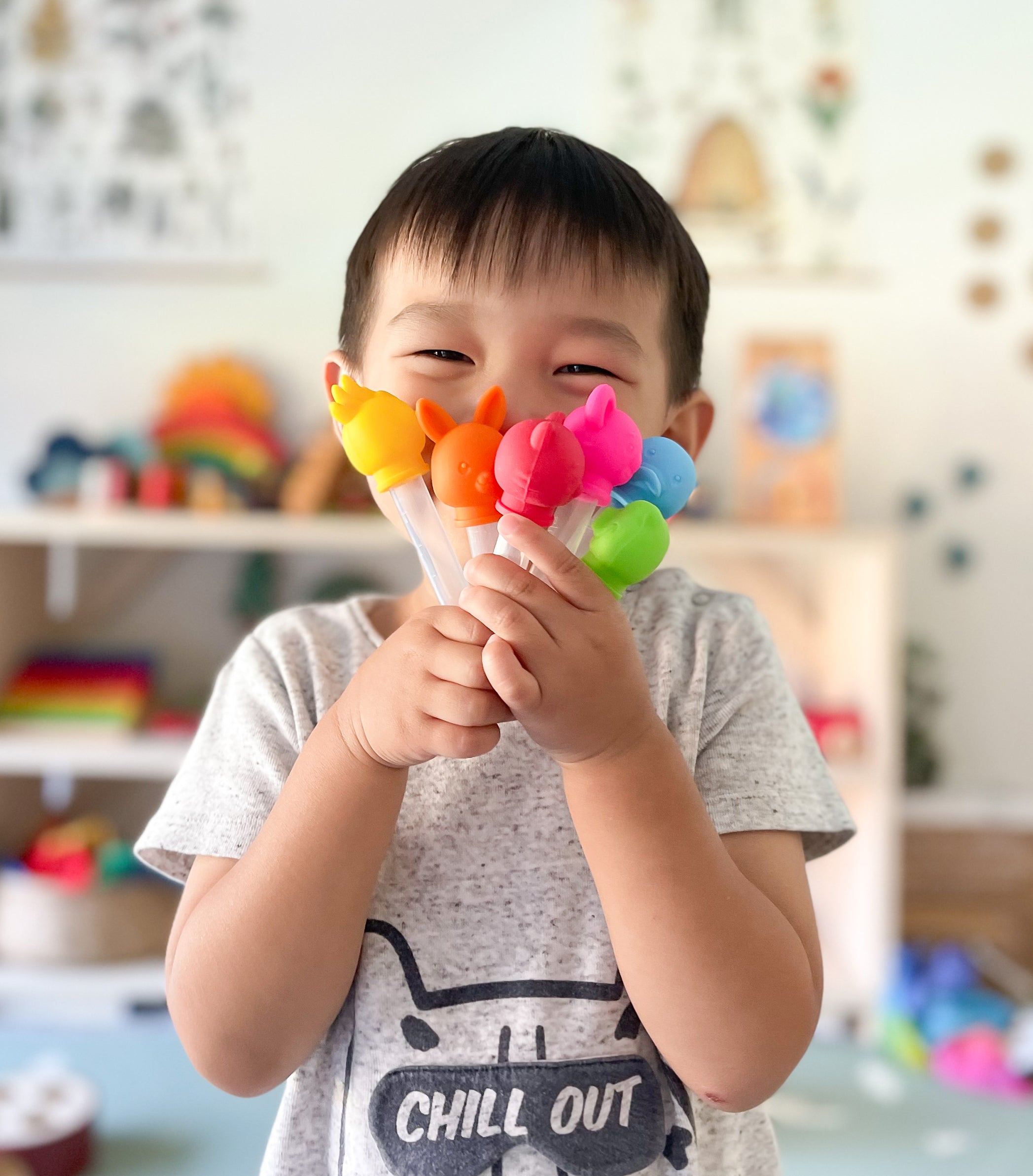 toddler with silicone Aussie Animal Drip Droppers for crafts and STEM for kids experiements