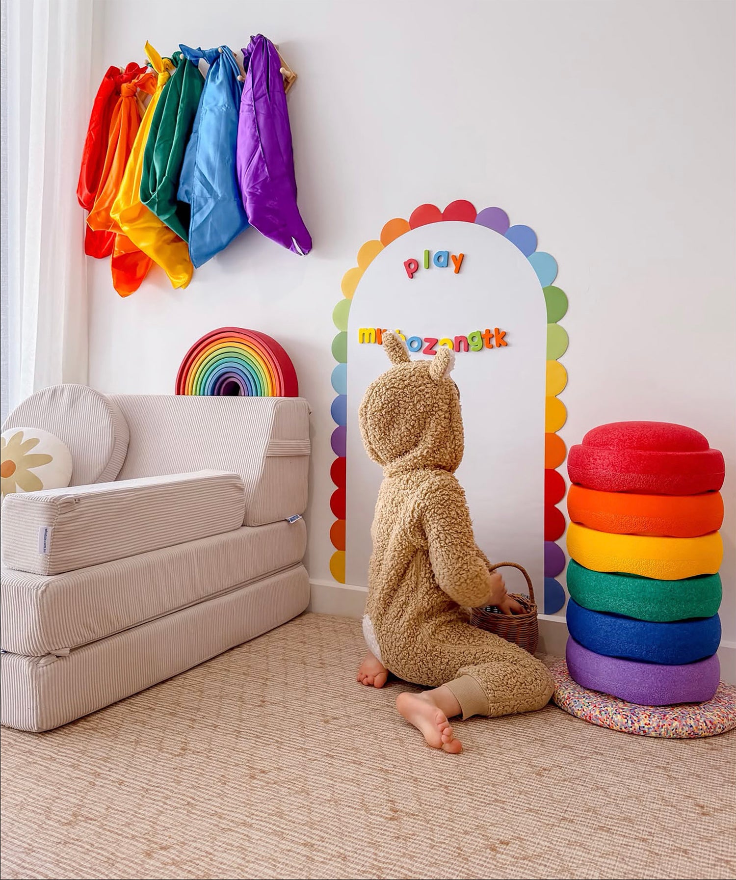 toddler playing with Curious Columbus Peel and Play Magnetic Wall decal and foam alphabet fridge magnets